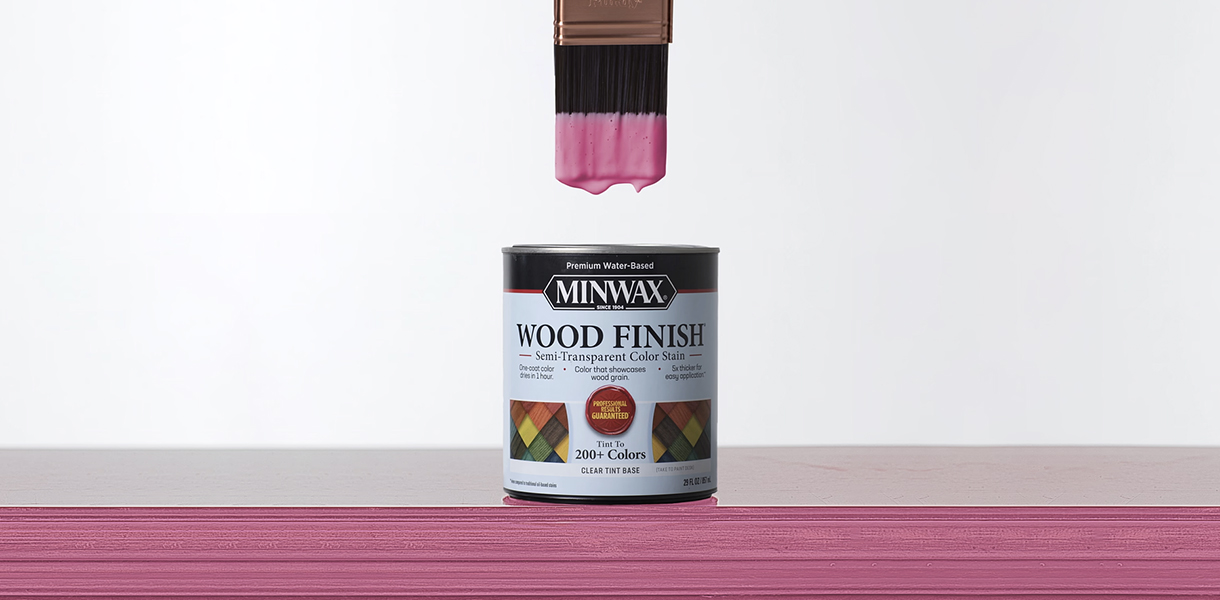 Paint brush dipped into quart can of Minwax Semi-Transparent Wood Finish Perfectly Pink 
