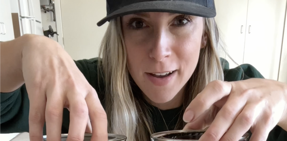 Person showing two cans of stains