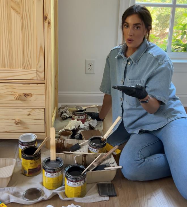 person with several stains preparing to mix stains