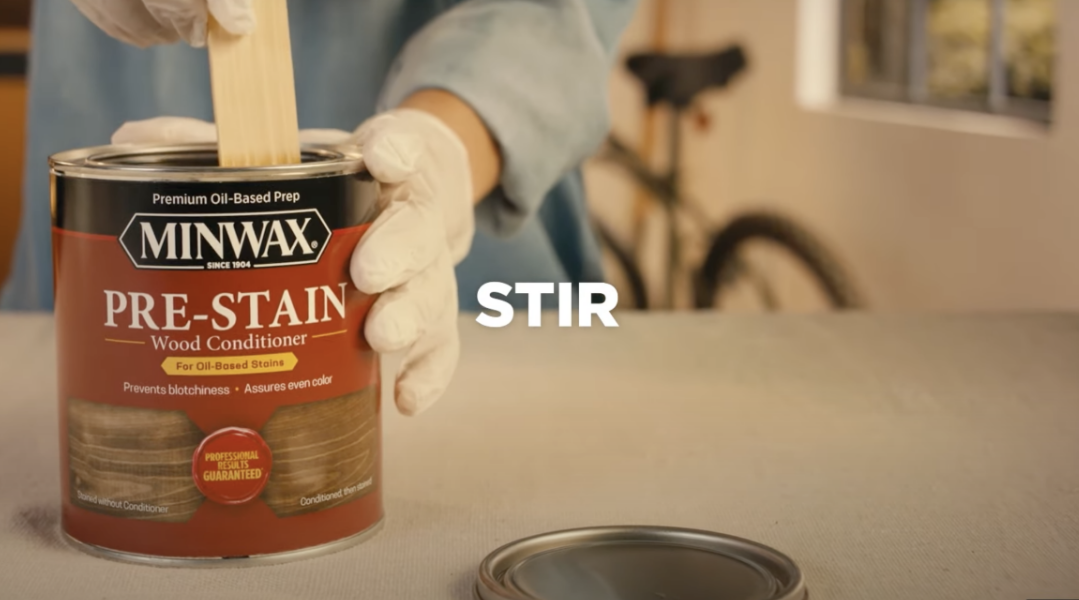 Stirring a can of Minwax Pre-Stain